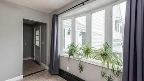 A room with a large window, a door leading to another room, and a tiled floor. - World Cup Boston Private 6-Acre Estate Sleeps 16 Less than 18 Min From Gillette (Taunton)