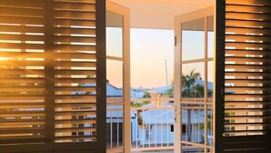 A view through a balcony door with a tiled floor and a railing. - Cullen Bay Retreat | Pool, Balcony & Marina Stroll (Larrakeyah)
