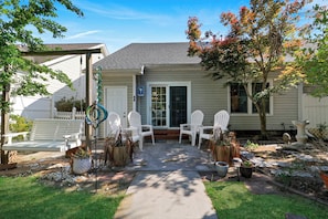 A house with a patio, white chairs, a swing, and potted plants. - Bluffton Park's own piece of Utopia, a charming single-level, 2-bedroom townhome (Bluffton)