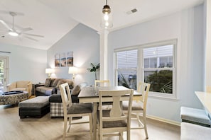A living room with a dining table, chairs, a sofa, and a ceiling fan. - Bluffton Park's own piece of Utopia, a charming single-level, 2-bedroom townhome (Bluffton)