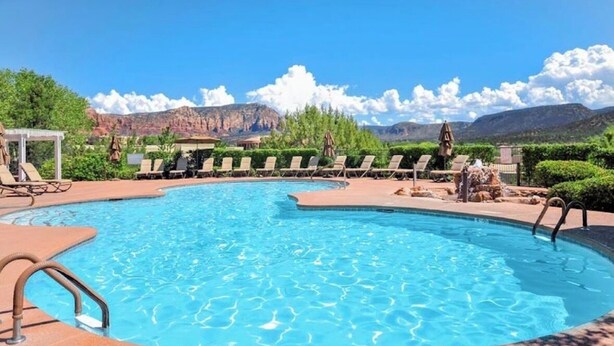 A swimming pool with lounge chairs, a pergola, and a mountain backdrop. - Luxury Grand Vacation Stay in Mountainous Sedona (Sedona)
