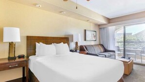 A hotel room with a large bed, a desk with a lamp, a sofa, and a balcony with a view. - Luxury Grand Vacation Stay in Mountainous Sedona (Sedona)