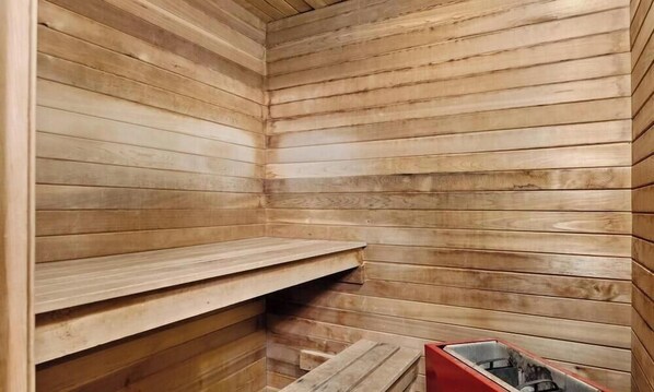 A sauna with wooden walls and benches.