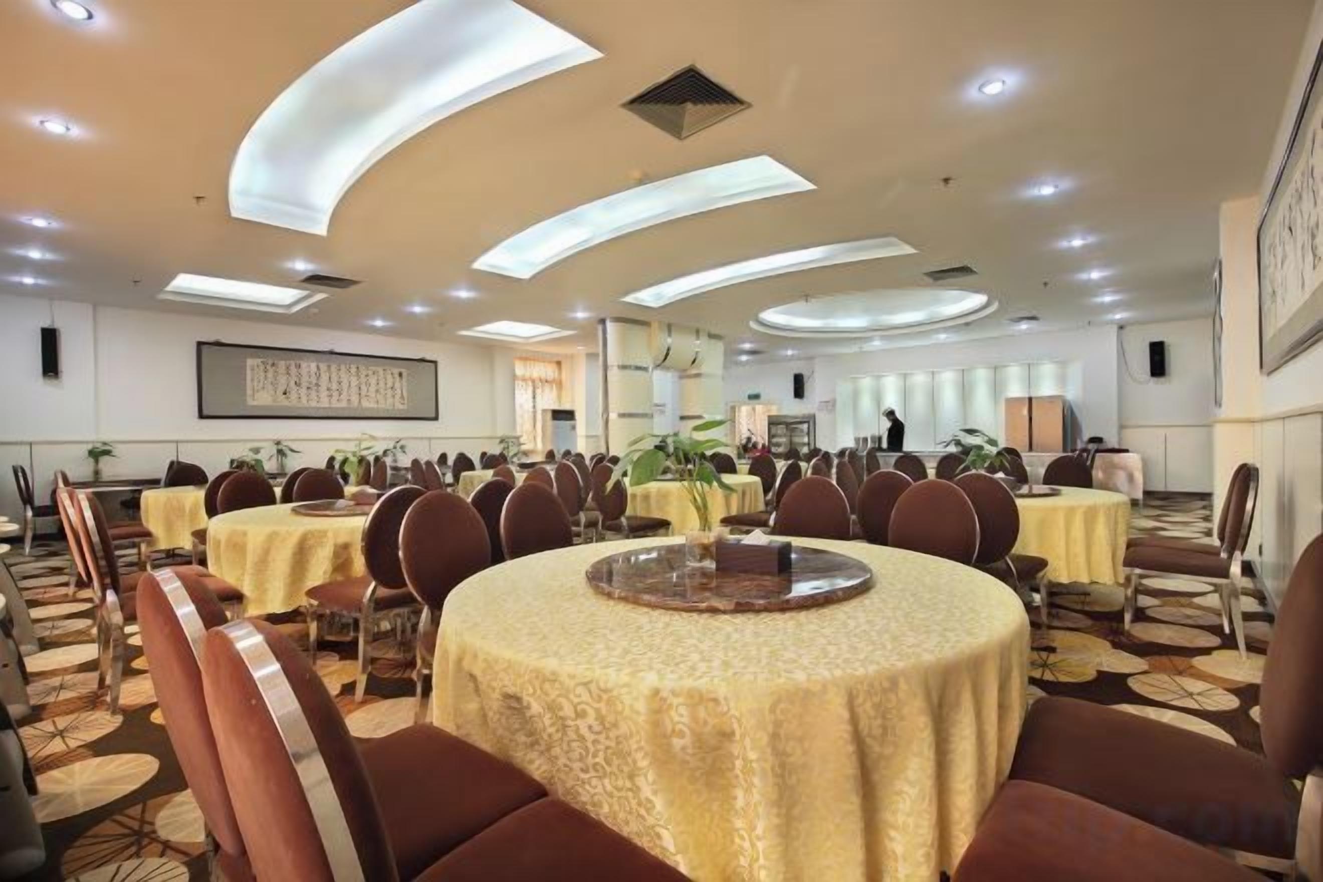 A conference room with round tables, chairs, and a large window.