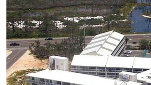 A multi-story hotel with a swimming pool and a parking area. - Beach Front Family Friendly Sleeps 8 3pools Seaview Resort (Orange Beach)