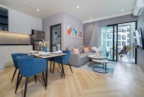 Ein stilvoller Wohnraum mit Essbereich, einer Couch und einem Balkon mit Blick.