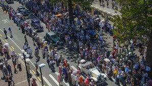 A crowded street scene with vintage cars and people. - The Rotten Apple Back Packers (Hastings)