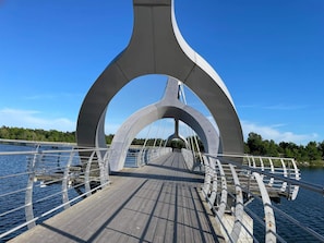 A pedestrian bridge with a wooden deck and metal railings. - 4 Star Holiday Home in Solvesborg (Sölvesborg)
