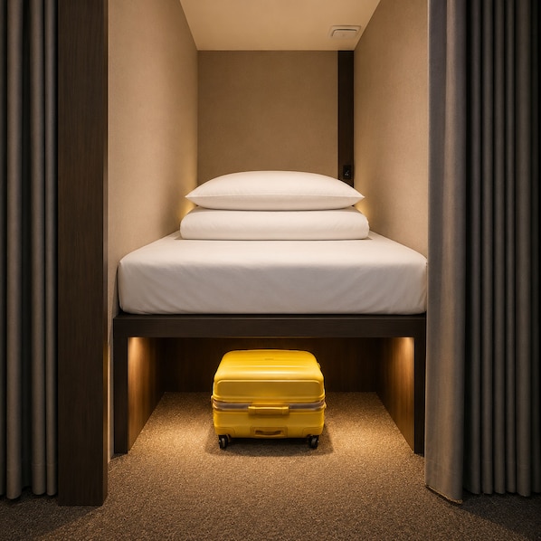 A compact room with a bed, a suitcase, and a light fixture. - OstelloMaree (Seoul)