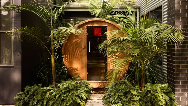 A wooden structure with a door, surrounded by lush greenery. - The Pavilion, Wamberal (Wamberal)
