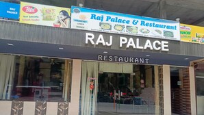 A restaurant named Raj Palace with a signboard advertising breakfast, lunch, and dinner. - Raj Palace (Joshimath)