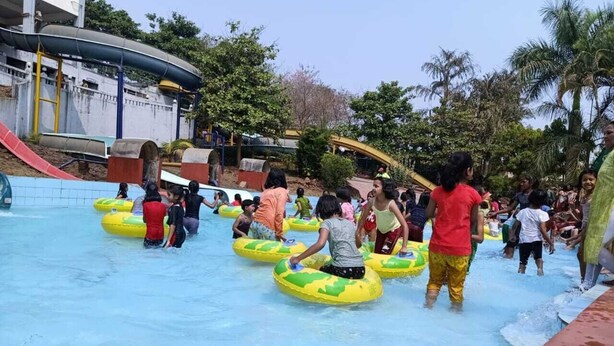 A water park with inflatable tubes, a pool, and a slide. - Shagun Resort & Water Park (Igatpuri)