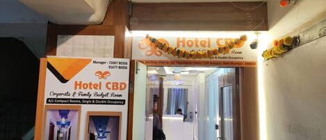 A hotel entrance with signs for 'Hotel CBD' and 'Corporate & Family Budget Room.'