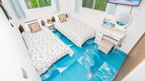 A room with two beds, a desk, a mirror, and a TV on the wall. -  Asagaya Room B｜1R｜10 Min to Shinjuku｜Budget Studio for 2 (Suginami City)