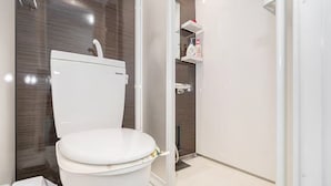 A modern bathroom with a toilet, shower, and storage shelves. -  Asagaya Room B｜1R｜10 Min to Shinjuku｜Budget Studio for 2 (Suginami City)