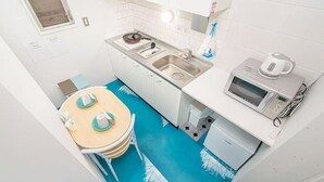 A compact kitchen with a sink, stove, microwave, and a small refrigerator. -  Asagaya Room B｜1R｜10 Min to Shinjuku｜Budget Studio for 2 (Suginami City)