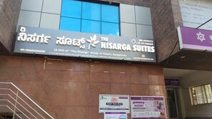 A hotel sign with contact information and location details.