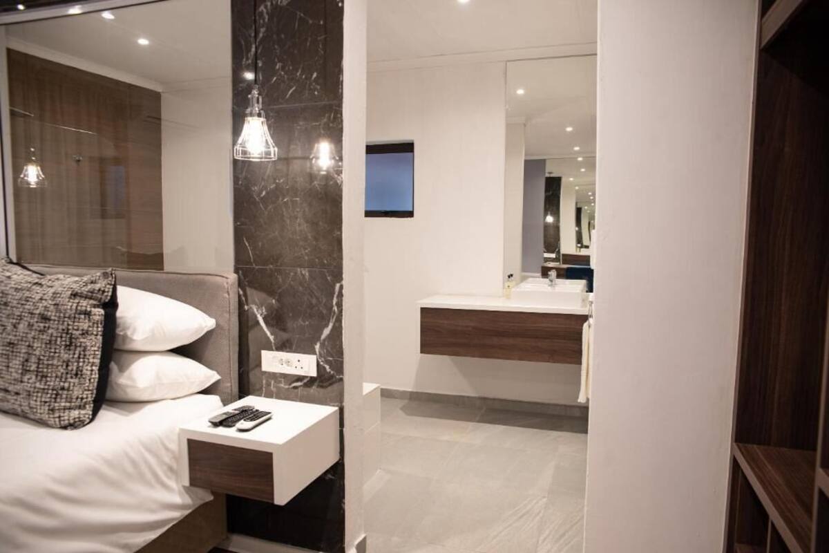 A modern bedroom with a bed, bedside table, and a nightstand.