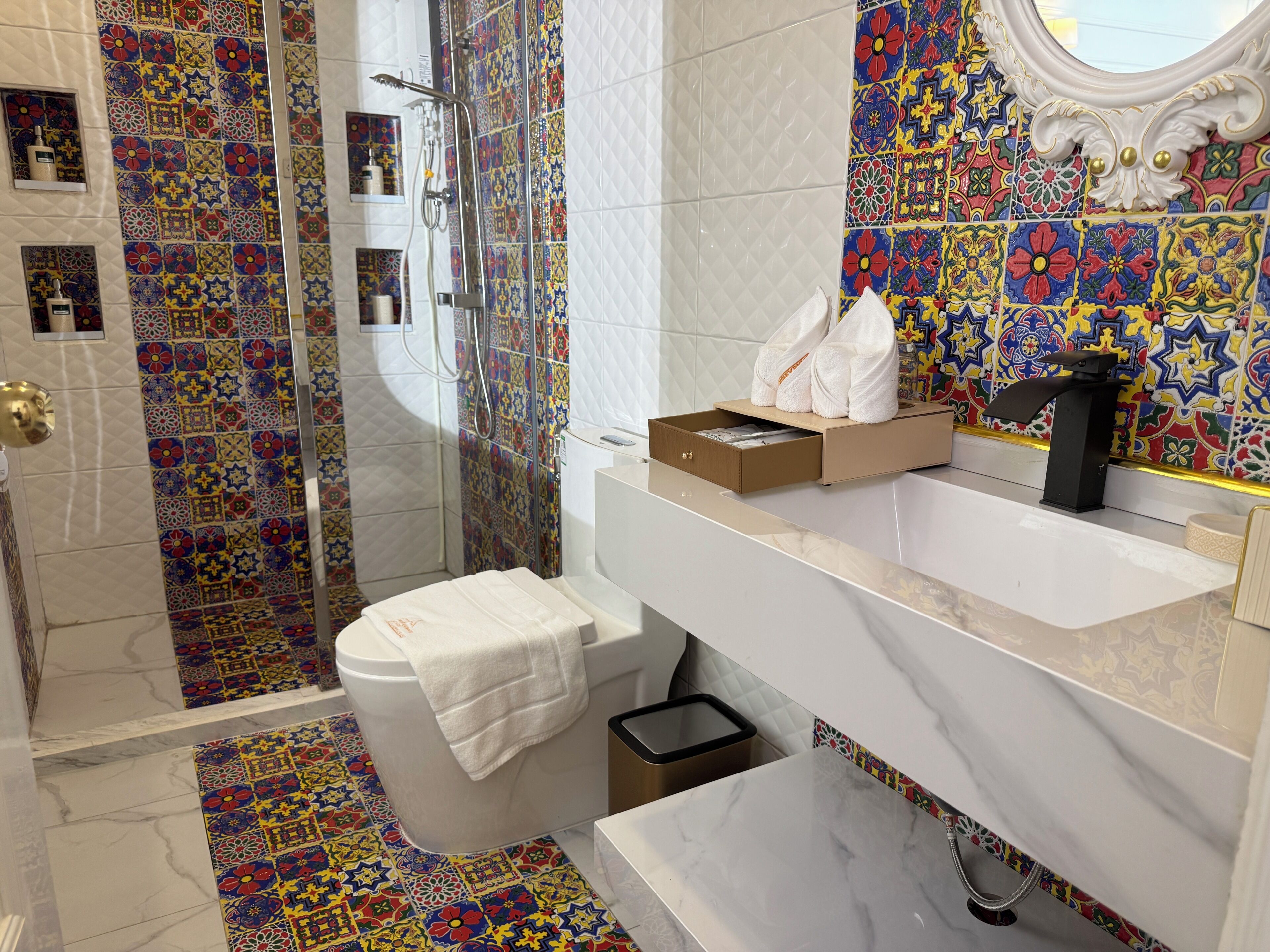 A bathroom with a shower, toilet, and sink.