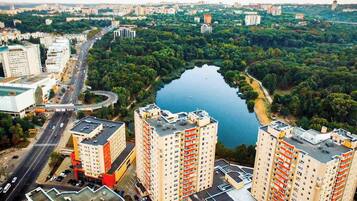 A high-rise building with multiple floors, a central courtyard, and a surrounding urban area with roads and greenery.