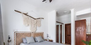 A bedroom with a bed, bedside lamp, and a macrame wall hanging. - 8205, Ocean Dream, Cabarete! (Cabarete)