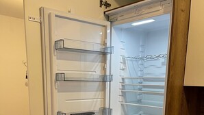 A modern kitchen with a built-in refrigerator, a microwave, and a sink.
