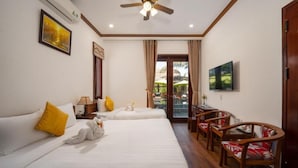 A hotel room with two beds, a ceiling fan, a TV, a dining table with chairs, and a view of the outdoors. - Ony Retreat Villas (Da Nang)
