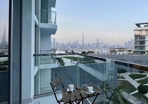 A modern building with a glass balcony overlooking a cityscape. - Modern Family Retreat w/ Dubai Skyline Views (Dubai)