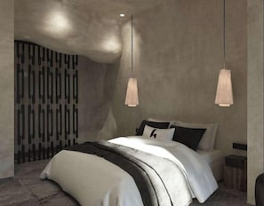 A modern bedroom with a large bed, a unique wall design, and pendant lighting. - Anemos Central Fira (Santorini)