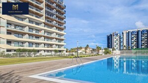 A modern hotel with a swimming pool, multiple balconies, and a well-maintained outdoor area. - Brisa Azul 2-bedroom apartment in punta prima, pool, gym, jacuzzi (Torrevieja)