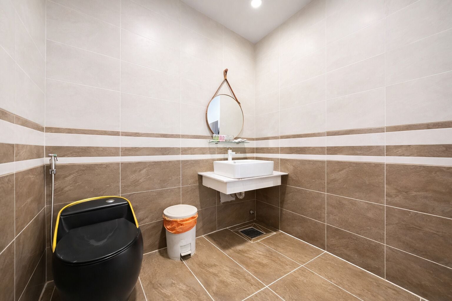 A bathroom with a shower, sink, mirror, and toilet.