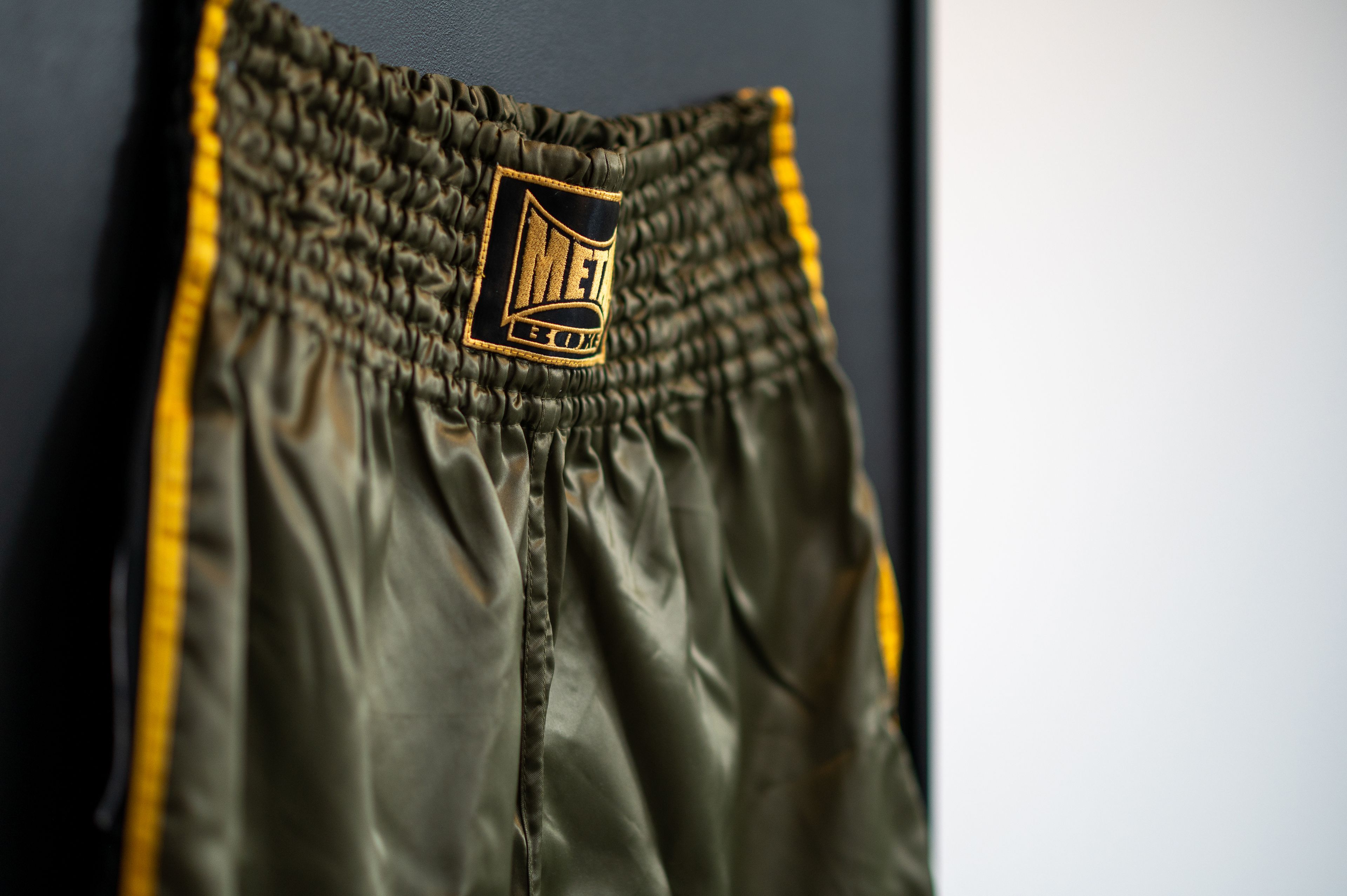 A close-up of a garment with a logo on the waistband.