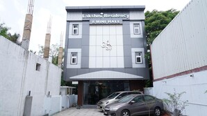 A building with a sign reading 'Lakshmi Residency & Mini Hall.'