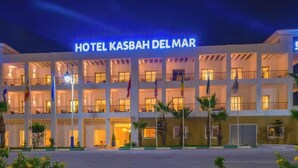 A multi-story hotel with a prominent sign reading 'HOTEL KASBAH DEL MAR.'