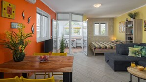 A modern living space with a dining area, a sofa, and a bed. - Apartment Lemon&Soul by Villas Guide (Crikvenica)