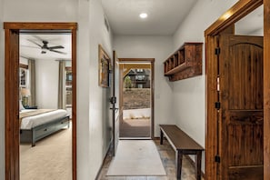 A hallway with a bed, a bench, a door, and a view to the outside. - NEW! Ski-In/Out Granby Ranch・Sleeps 16 ・Arcade (Granby)