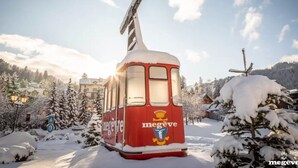 A red cable car with 'megeve' branding parked in a snowy village. - K1 facing the slopes ski in / ski out Megève (Megève)
