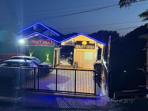A building with a sign reading 'HAZY HILL' and a neon sign above the entrance. - Hazy hill (Mussoorie)