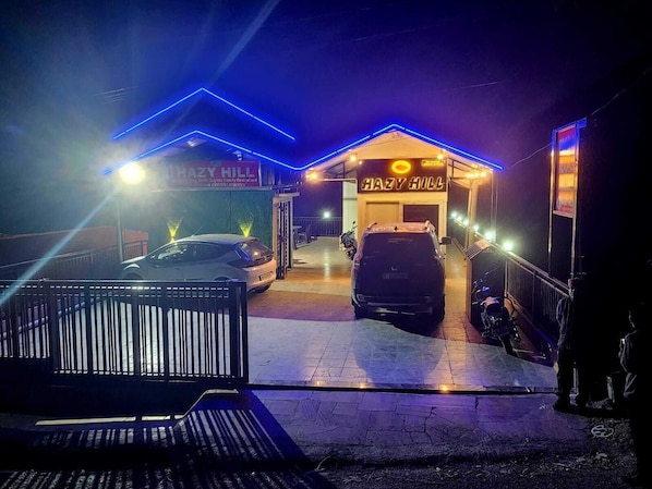 A building with a sign reading 'HAZY HILL' and a car parked in front. - Hazy hill (Mussoorie)