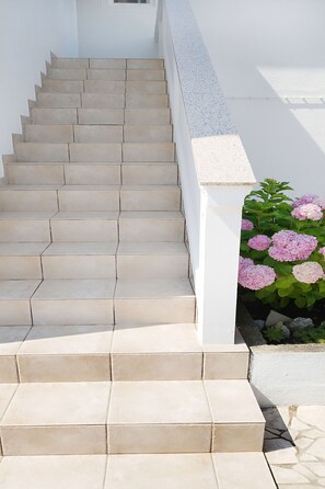 A set of beige tiled stairs leading up to a white wall. - Cozy seafront flat on the Island of Rab (Rab)