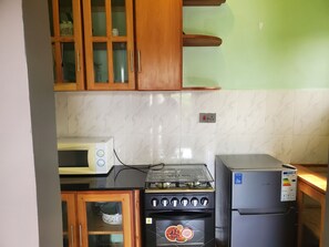 Comfort Triple Room, Balcony | Private kitchen | Mini-fridge, microwave, oven, cookware/dishes/utensils - ESE HOMESTAY MANYARA (Lake Manyara National Park)