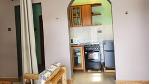 A kitchen with a stove, oven, and cabinets.