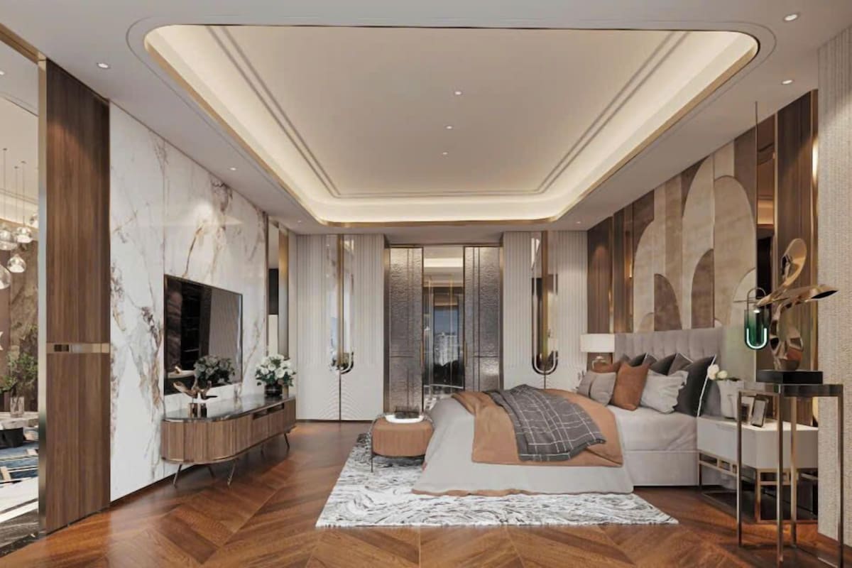 A modern bedroom with a large bed, a TV, and a console table.