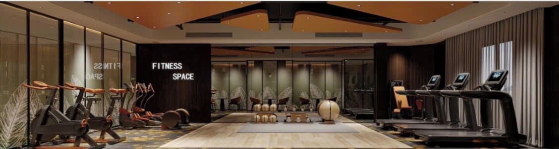 A fitness space with exercise equipment, a large mirror, and a wall with the words 'FITNESS SPACE'.