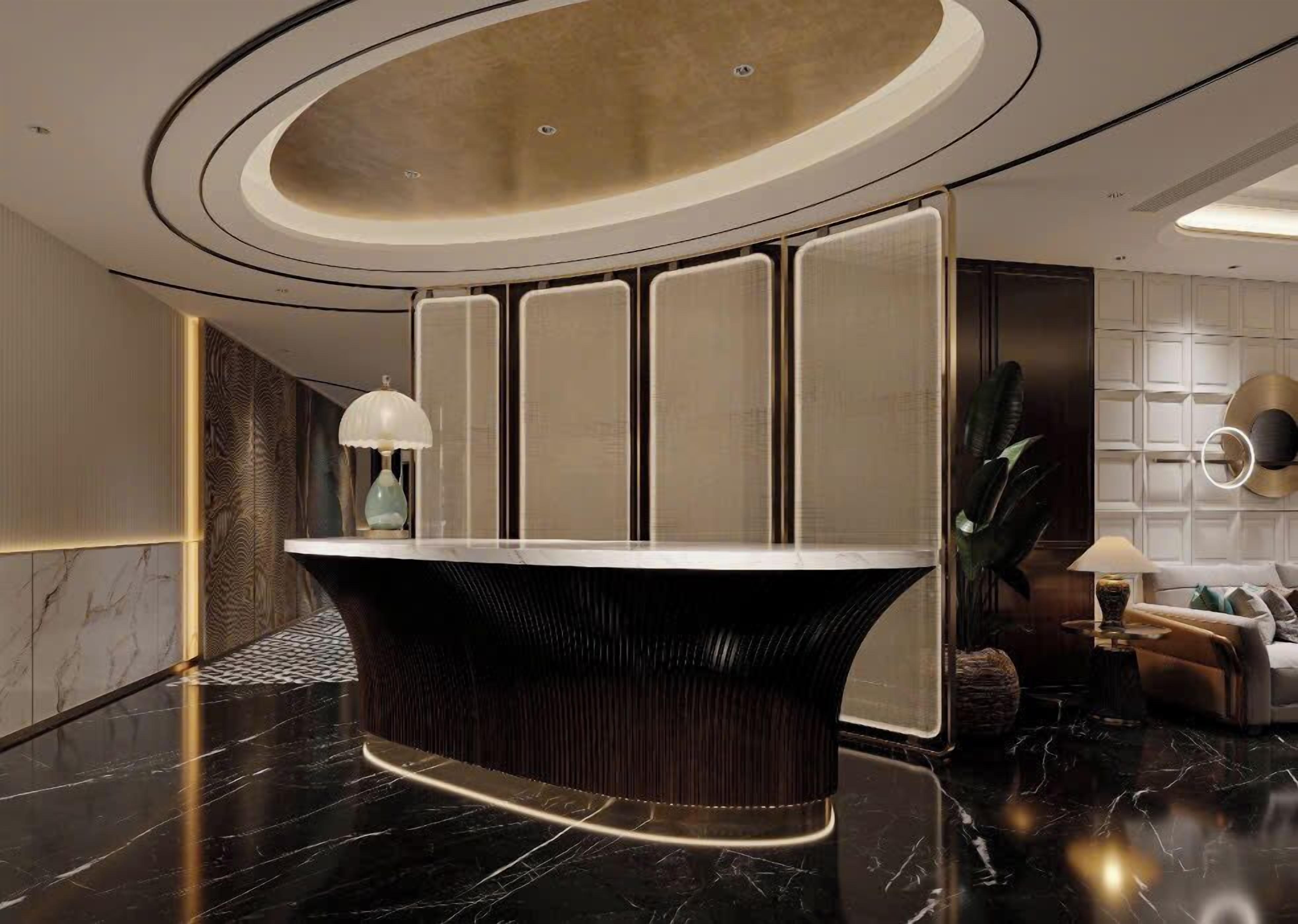 A modern reception area with a curved reception desk, a large potted plant, and a seating area with a sofa and lamp.