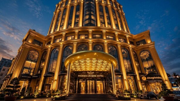 A grand hotel entrance with a prominent archway, a large staircase, and a luxury store. - Phoenix Crowne Vinh Hotel (Thanh Vinh)