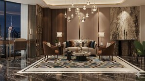 A modern living room with a sofa, two armchairs, a coffee table, and a chandelier. - Phoenix Crowne Vinh Hotel (Thanh Vinh)