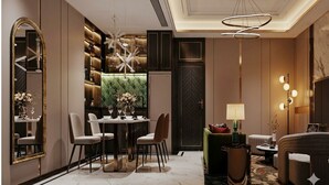 A modern interior with a dining area, a sofa, and a lamp. - Phoenix Crowne Vinh Hotel (Thanh Vinh)