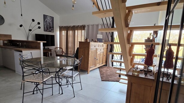 A spacious kitchen with a dining area, wooden beams, and a large window. - Villa ma sueur - house with a story. (Coutras)
