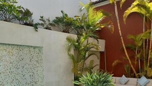 A pool with artificial grass, lounge chairs, and potted plants. - Villa Zawaia B&B Adults Only (Lagos)
